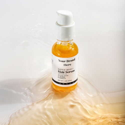 Hair serum bottle with a white label on a white background with water